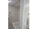 Bathroom with white subway tile shower and brass fixtures at 701 Harlan St # E53, Lakewood, CO 80214