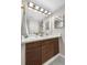 Stylish bathroom showcasing a modern vanity with decorative wood and a large, well-lit mirror at 701 Harlan St # E53, Lakewood, CO 80214