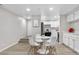 Dining area with a modern white table and chairs is conveniently located off the kitchen at 701 Harlan St # E53, Lakewood, CO 80214