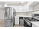 Contemporary kitchen featuring stainless steel appliances and white cabinetry at 701 Harlan St # E53, Lakewood, CO 80214