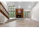Bright living room features a wood fireplace, large windows, and access to a balcony at 701 Harlan St # E53, Lakewood, CO 80214