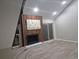 Open living room with vinyl floors, fireplace, and sliding glass door at 701 Harlan St # E53, Lakewood, CO 80214