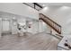 Bright living area features a staircase, dining area, and an open view into the kitchen space at 701 Harlan St # E53, Lakewood, CO 80214