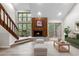 Bright living room features a wood fireplace, large windows, and access to a balcony at 701 Harlan St # E53, Lakewood, CO 80214