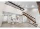 Inviting living room with open floor plan, staircase, and modern flooring, great for entertaining at 701 Harlan St # E53, Lakewood, CO 80214