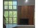Inviting living room features a wood-burning fireplace and a large window with verdant views at 701 Harlan St # E53, Lakewood, CO 80214