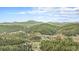 Majestic aerial view showcasing a sprawling landscape with mountains, lush forests, and a highway at 20 W Ranch Trl, Morrison, CO 80465