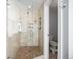 Modern bathroom with glass-enclosed shower featuring tiled walls and floor and a small built-in shelf at 20 W Ranch Trl, Morrison, CO 80465