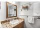 Bathroom with granite counters, framed mirror, modern fixtures and decorative shelving at 20 W Ranch Trl, Morrison, CO 80465