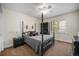 Comfortable bedroom featuring a four-poster bed, ceiling fan, and a built-in bookcase at 20 W Ranch Trl, Morrison, CO 80465