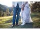 Lower shot of a dressed couple standing on a green grassy hillside at 20 W Ranch Trl, Morrison, CO 80465