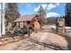 Gated community entrance with a rustic stone gate and mature trees at 20 W Ranch Trl, Morrison, CO 80465