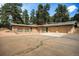 Equestrian barn featuring multiple stalls, an arched entryway, and a connected driveway at 20 W Ranch Trl, Morrison, CO 80465