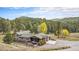 A ranch style house surrounded by lush trees, a patio and outdoor seating at 20 W Ranch Trl, Morrison, CO 80465