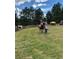 Horse property featuring two riders on horseback with surrounding green pasture and wooded landscape at 20 W Ranch Trl, Morrison, CO 80465