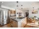 Well-equipped kitchen with stainless appliances, granite island, and adjacent dining area at 20 W Ranch Trl, Morrison, CO 80465