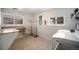 Functional laundry room with tile floors, ample counter space, and a front-load washer and dryer at 20 W Ranch Trl, Morrison, CO 80465