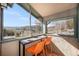 Cozy screened patio with bar seating and a scenic view, perfect for relaxation and entertainment at 20 W Ranch Trl, Morrison, CO 80465
