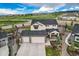 Stunning aerial view of home featuring large driveway, two-car garage, and landscaped front yard at 16881 Roaming Elk Dr, Monument, CO 80132
