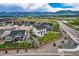 The backyard has a well-maintained lawn, surrounded by a wooden fence, mountains visible in the background at 16881 Roaming Elk Dr, Monument, CO 80132