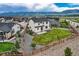 The backyard has a lush lawn, surrounded by a wooden fence, and xeriscaped rocks at 16881 Roaming Elk Dr, Monument, CO 80132