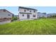 Large backyard with lush green lawn, wood fencing, and the home's exterior at 16881 Roaming Elk Dr, Monument, CO 80132