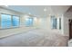 Finished basement with windows for natural light, neutral carpet, and access to upper levels at 16881 Roaming Elk Dr, Monument, CO 80132