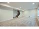 Spacious basement with neutral carpet, recessed lighting, and staircase leading to upper levels at 16881 Roaming Elk Dr, Monument, CO 80132