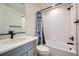 Bright bathroom featuring a vanity with quartz countertop, black fixtures, and subway tiled shower at 16881 Roaming Elk Dr, Monument, CO 80132