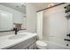 Contemporary bathroom with gray vanity, quartz countertop, and subway tile shower at 16881 Roaming Elk Dr, Monument, CO 80132