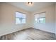 Bright bedroom with two windows and neutral walls, featuring beautiful laminate flooring at 16881 Roaming Elk Dr, Monument, CO 80132