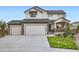 Attractive two-story home featuring a three-car garage and stone accents, showcasing its curb appeal at 16881 Roaming Elk Dr, Monument, CO 80132