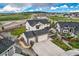 Stunning aerial view of a home with a three-car garage and manicured landscaping at 16881 Roaming Elk Dr, Monument, CO 80132