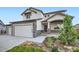 Charming two-story home with a covered porch, beautiful landscaping and stone accents at 16881 Roaming Elk Dr, Monument, CO 80132