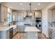 A modern kitchen features gray cabinets, a large island, and stainless steel appliances at 16881 Roaming Elk Dr, Monument, CO 80132