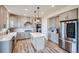 Modern kitchen featuring gray cabinets, a center island, stainless steel appliances, and stylish backsplash at 16881 Roaming Elk Dr, Monument, CO 80132