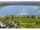 An aerial view of green community park and a blue lake shimmering in the sunlight against a backdrop of clear sky at 2616 Utica St, Denver, CO 80212
