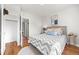 Cozy bedroom with hardwood floors, a comfortable bed, and a closet for storage at 2616 Utica St, Denver, CO 80212