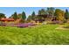 A manicured community park with pergolas, benches, flowers, and a beautiful green lawn at 2616 Utica St, Denver, CO 80212