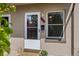 Inviting front entrance with a decorative storm door, flowers, and a welcome mat at 2616 Utica St, Denver, CO 80212