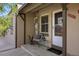 Charming front porch with a chair, side table, and a welcoming 'hello' doormat at 2616 Utica St, Denver, CO 80212