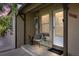 Charming front porch with a chair, side table, and a welcoming 'hello' doormat at 2616 Utica St, Denver, CO 80212
