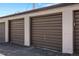 Three-bay garages with brown doors and white trim provide ample parking and storage at 2616 Utica St, Denver, CO 80212