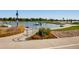 Picturesque lake view with a walking path, vibrant flowers, and boats enhancing the waterfront ambiance at 2616 Utica St, Denver, CO 80212