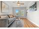 Bright living room with hardwood floors, a ceiling fan, modern furnishings, and abundant natural light at 2616 Utica St, Denver, CO 80212
