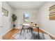 Well-lit office space with a desk, chair, hardwood floors, and a window with a view at 2616 Utica St, Denver, CO 80212