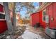 Backyard with patio, red brick walls, and mature trees at 403 W 3Rd Ave, Denver, CO 80223