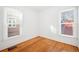 Simple bedroom with hardwood floors and two windows at 403 W 3Rd Ave, Denver, CO 80223