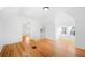 Large bedroom with hardwood floors, two windows, and access to hallway at 403 W 3Rd Ave, Denver, CO 80223