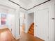 Home hallway with hardwood floors and view of kitchen and staircase at 403 W 3Rd Ave, Denver, CO 80223